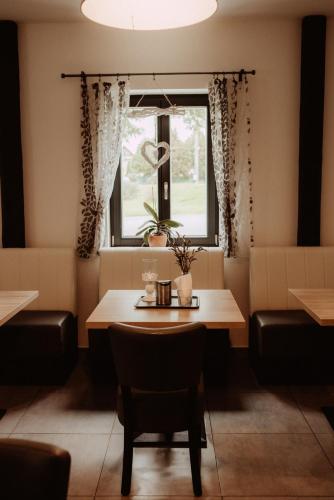 a dining room with a table and a window at Penzion Merica in Bor