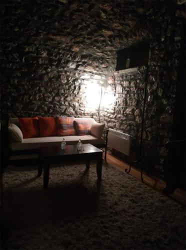a living room with a couch and a table at Despotikon Dimitsana Guest house - Ξενώνας Δεσποτικόν Αντωνόπουλου in Dhimitsana