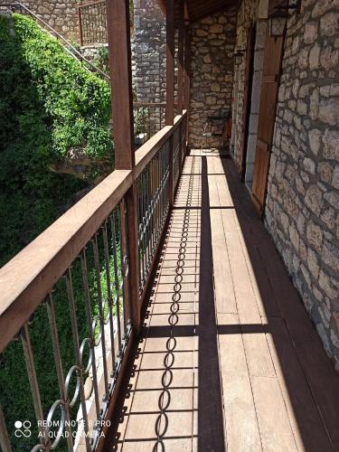 a walkway on a porch of a building at Despotikon Dimitsana Guest house - Ξενώνας Δεσποτικόν Αντωνόπουλου in Dhimitsana