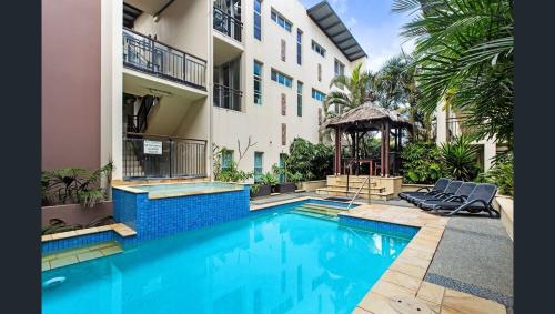 a swimming pool in front of a building at 3 Bedroom Central Beachside Kingscliff Apartment with Pool in Kingscliff