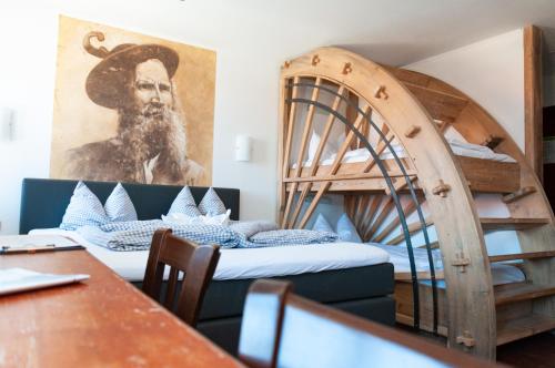 a room with two bunk beds and a table at Landhotel & Gasthof Baiernrain in Baiernrain