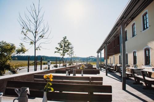 a row of wooden benches next to a building at Landhotel & Gasthof Baiernrain in Baiernrain