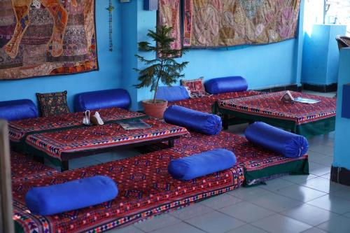 a room with blue chairs and tables with blue walls at Dylan Cafe And Guest House in Jodhpur