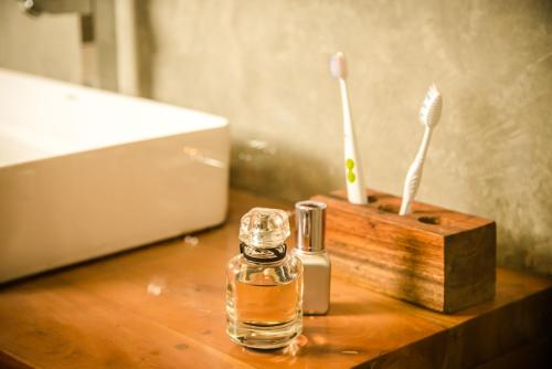 a bottle of perfume and tooth brushes on a table at Infinity of Sri Lanka in Paiyagala South