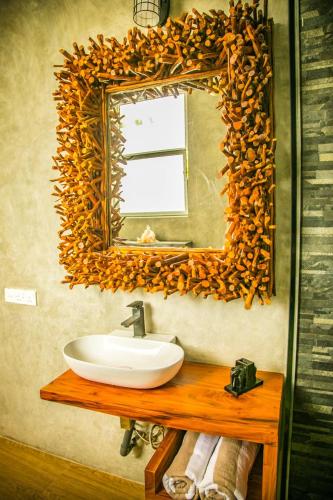 a bathroom with a sink and a mirror at Infinity of Sri Lanka in Paiyagala South
