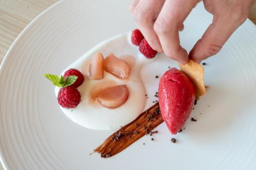 a plate of food with strawberries and cinnamon sticks at Schlegelhof in Kirchzarten