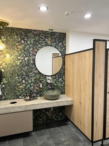 a bathroom with a sink and a mirror at Landhotel & Gasthof Baiernrain in Baiernrain