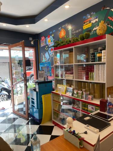 a room with a store with a book shelf at D​ Luck​ Hostel in Kanchanaburi