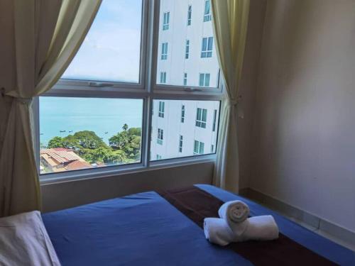 a bedroom with a bed with a large window at Mansion One Luxurious Seaview Vacation Homes in George Town