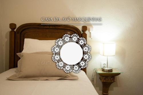 a wreath on a bed with a mirror on it at Casa da Avó Marquinhas in Carlão