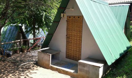 a small house with a brick door and stairs at KK Hut in Pai