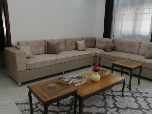 a living room with a couch and two tables at Petra Guests home in Wadi Musa