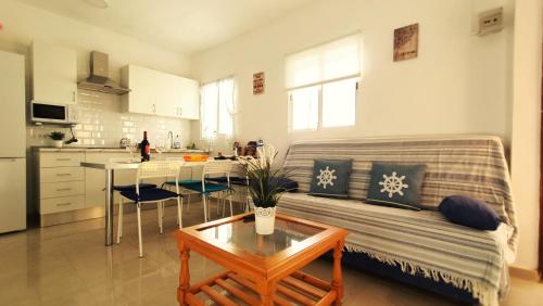 a living room with a couch and a table at alquilaencanarias Casa La Playa La Gomera in Alojera