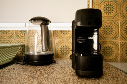 a coffee maker and a blender on a counter at Casa da Avó Marquinhas in Carlão