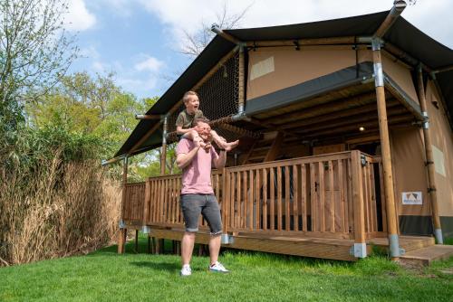 two men standing in front of a house at Resort Rhederlaagse Meren in Lathum