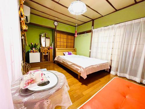 旅馆yo ko في Fuchisaki: غرفة نوم بسريرين وطاولة فيها