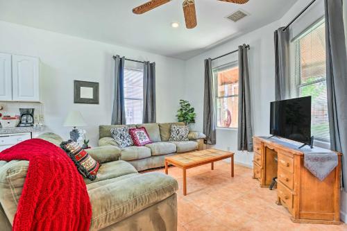 a living room with a couch and a tv at Cozy and Relaxing Eloy Apartment with Pool Access in Eloy