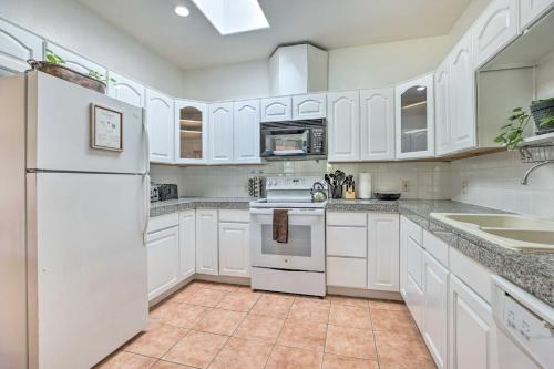 a kitchen with white cabinets and a white refrigerator at Cozy and Relaxing Eloy Apartment with Pool Access in Eloy