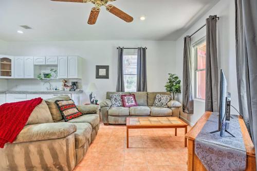 a living room with a couch and a tv at Cozy and Relaxing Eloy Apartment with Pool Access in Eloy