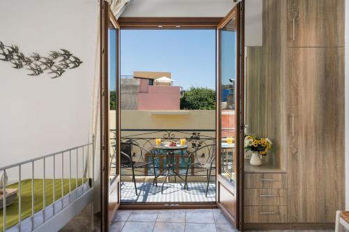 a balcony with a glass door leading to a patio at Porto Orion Studios in Chania Town