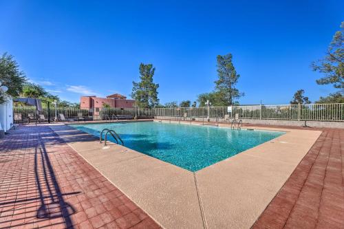 a swimming pool with blue water and a fence at Cozy and Relaxing Eloy Apartment with Pool Access in Eloy
