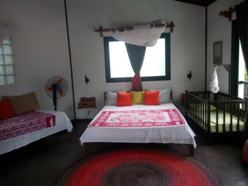 馬哈贊加的住宿－BELINTA plage DUPLEX，一间卧室配有一张大床和红色地毯。