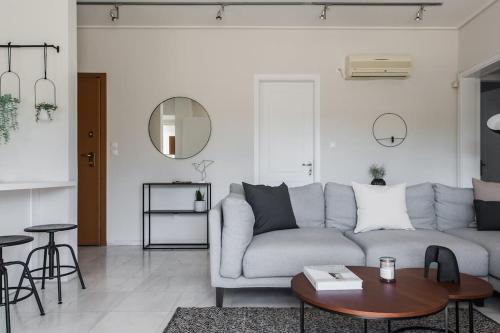 a living room with a couch and a table at Magnificent 2BR Apartment in Marousi by UPSTREET in Athens