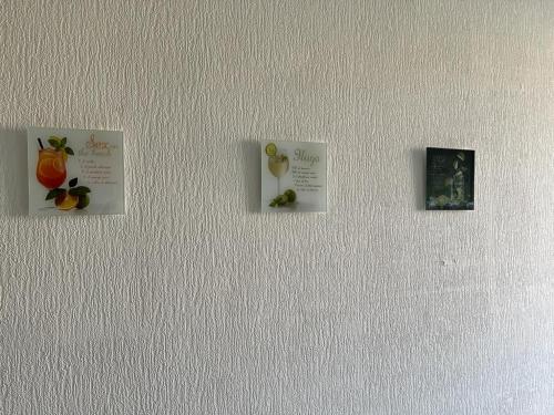 a wall with three pictures of fruit on it at Wiehengebirgs Fernblick App1 in Bad Essen