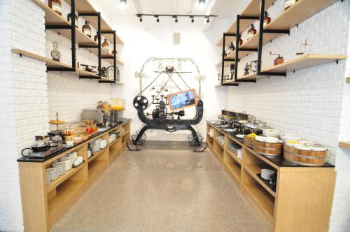a kitchen with shelves and a table in a room at Forty Winks Phuket Hotel in Patong Beach
