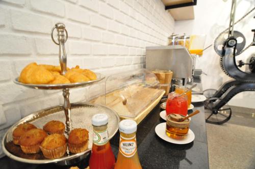 a counter with a tray of donuts on a table at Forty Winks Phuket Hotel in Patong Beach