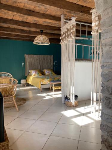 a bedroom with a bed in a room with green walls at Le Clos Bô-m in Marignieu