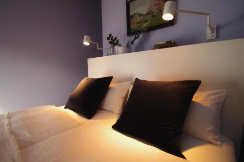 a bedroom with a bed with two black pillows at quartier26 in Nuremberg