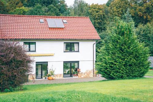 una casa bianca con tetto solare e cortile di Lipolas-slowlife&guesthouse a Jurków