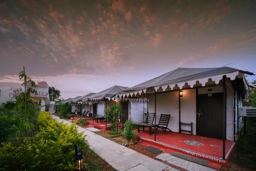 a row of cottages with a red carpet at Ranthambore Nature Camp Resort in Sawāi Mādhopur