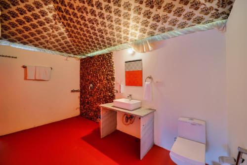 a bathroom with a sink and a toilet at Ranthambore Nature Camp Resort in Sawāi Mādhopur