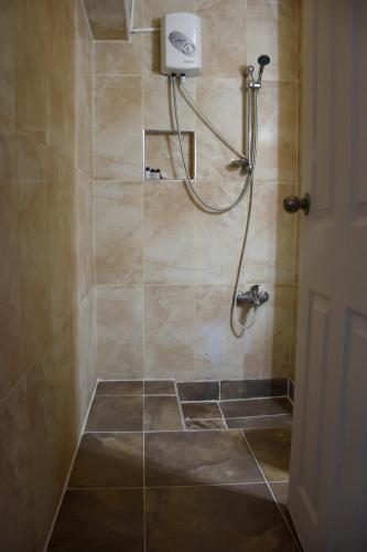 a shower with a shower head in a bathroom at Yalçın Otel in Antalya
