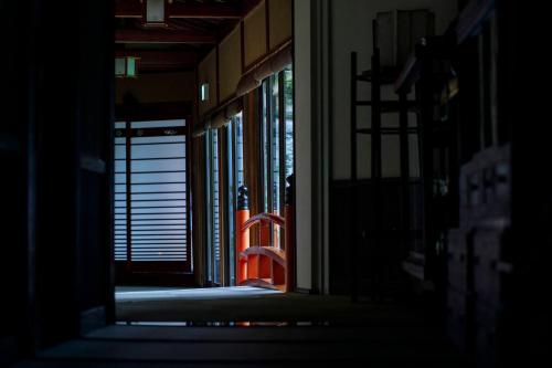 a hallway of a building with an open door at Busuitei in Hida
