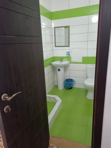 a bathroom with a sink and a toilet at Shaarei Zion in Umanʼ