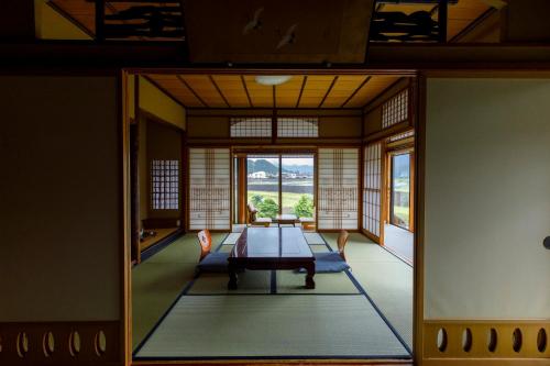 a room with a table in a room with a window at Busuitei in Hida