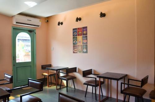 a row of tables and chairs in a room at HideSeek Hostel Vientiane Thai embassy in Vientiane