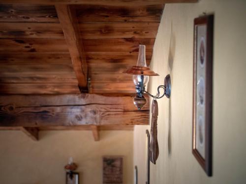 a lamp on the corner of a room with wooden ceilings at Cabana Barbu in Făgăraş