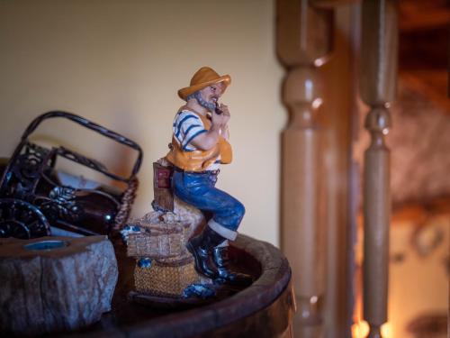 a figurine of a cowboy sitting on a barrel at Cabana Barbu in Făgăraş
