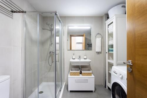 a white bathroom with a shower and a sink at COSTA MAGALLANES BEACH LA TEJITA in Granadilla de Abona