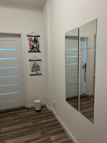 a bathroom with a mirror and a door at Lovely flat in the city center self-check in Bratislava