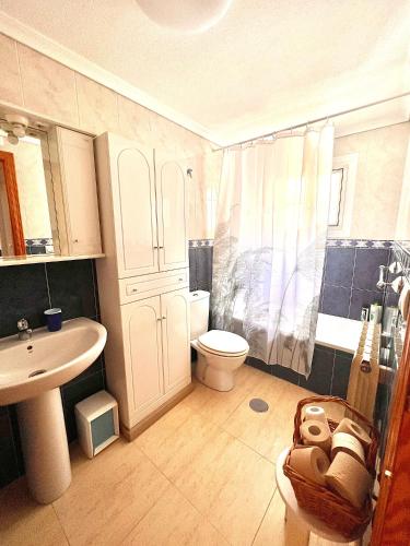 a bathroom with a toilet and a sink and a shower at Blue Serena - Top floor overlooking the nature in Puerto Marino