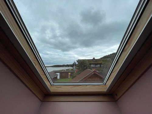 a window in a room with a view of the water at Poilsis Preiloje-91 in Neringa