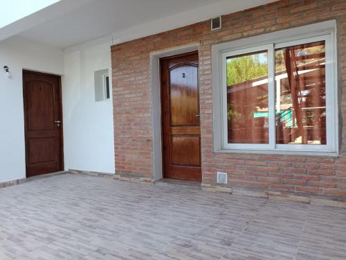 una habitación vacía con dos puertas y una pared de ladrillo en Givarolif en Salta