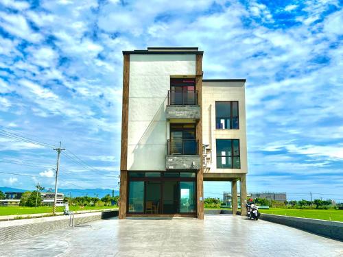 a building with a motorcycle parked in front of it at Xin yi in Wujie