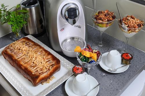 a counter with a mixer and a cake and drinks at Luna Bianca in Had Nes