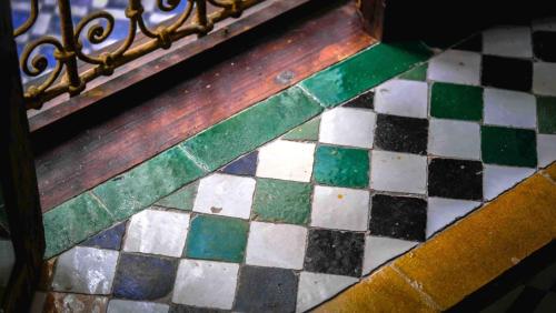 a colorful tile floor with a metal railing at Palais Nazha Fes - Luxury Lodging in Fès